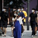 Pedestrians wearing masks to prevent the spread of the coronavirus disease (COVID-19) walk in a shopping district in Seoul, South Korea, August 20, 2020. REUTERS/Kim Hong-Ji