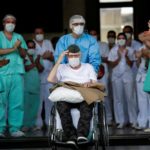 A 99-year-old former WWII combatant gestures as he leaves the hospital after being treated for COVID-19. Photo: Reuters/Ueslei Marcelino