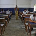 Students wearing protective masks listen to their teacher as they maintain social distancing in a classroom of Central Model School during a demonstration session for the students, parents and teaching staff before the reopening of the school, as India eases lockdown restrictions that were imposed to slow the spread of the coronavirus disease (COVID-19), at Barrackpore on the outskirts of Kolkata, India, June 8, 2020. REUTERS/Rupak De Chowdhuri
