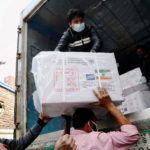 Workers unload a pickup van that carries Oxford-Astrazeneca COVID-19 vaccines which arrived from India as a gift to Bangladesh, in Dhaka