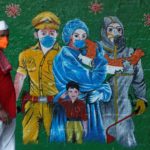 A man wearing a protective mask walks past a mural of frontline workers amidst the spread of the coronavirus disease (COVID-19), in Mumbai