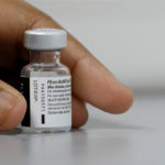 FILE PHOTO: A medical worker prepares to dilute a vial of Pfizer-BioNTech vaccine at a coronavirus disease (COVID-19) vaccination center in Singapore