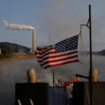 FILE PHOTO: The U.S. flag flies on a towboat as it passes the W. H. Sammis Power Plant along the Ohio River in Stratton