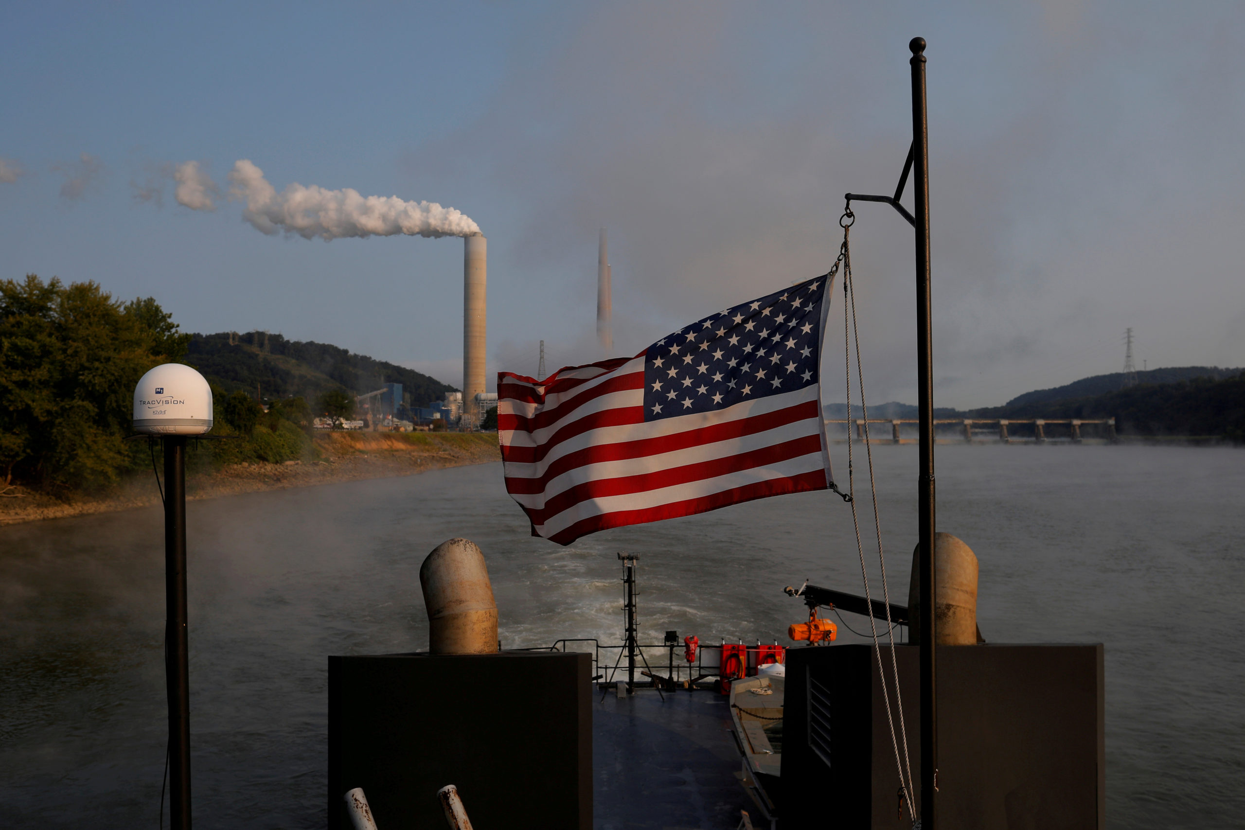 FILE PHOTO: The U.S. flag flies on a towboat as it passes the W. H. Sammis Power Plant along the Ohio River in Stratton