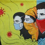 FILE PHOTO: Man wearing a protective mask walks past a graffiti amidst the spread of COVID-19, in Navi Mumbai