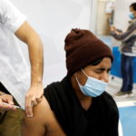 An agricultural worker from Nepal receives a vaccination against the coronavirus disease (COVID-19) at a temporary Clalit healthcare maintenance organisation (HMO) centre, at a sports hall in Netivot