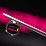 AstraZeneca logo is reflected in a drop on a syringe needle in this illustration photo
