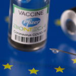 Vials labelled "Pfizer BioNtech coronavirus disease (COVID-19) vaccine" placed on displayed EU flag are seen in this illustration picture taken