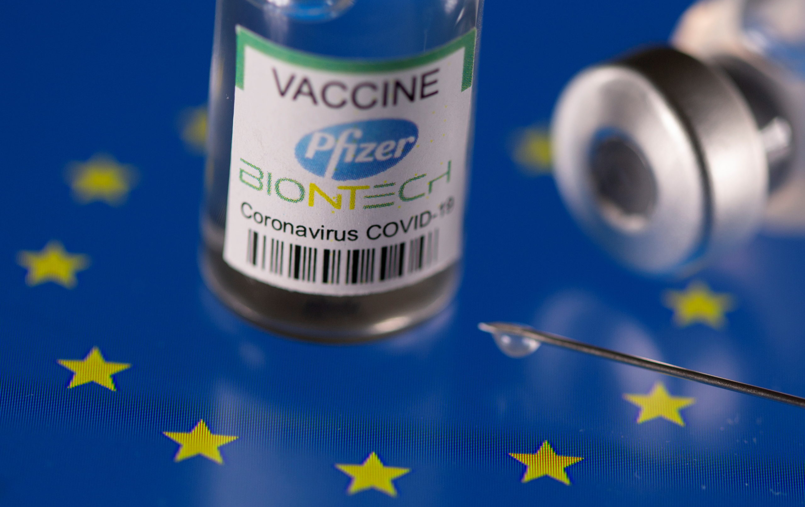 Vials labelled "Pfizer BioNtech coronavirus disease (COVID-19) vaccine" placed on displayed EU flag are seen in this illustration picture taken