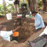 Members of the local community working with a team of archaeologists share finds in Belize
