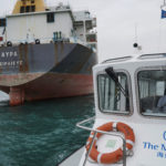 Mission to Seafarers boat travels past a bulk carrier in Hong Kong