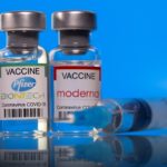 FILE PHOTO: Picture illustration of vials with Pfizer-BioNTech and Moderna coronavirus disease (COVID-19) vaccine labels