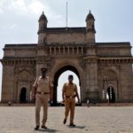 FILE PHOTO: Police officers patrol at the empty Gateway of India monument, amidst the spread of coronavirus disease (COVID-19), in Mumbai