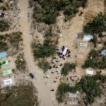 A picture taken with a drone shows people carrying the body of a man who died due to the coronavirus disease (COVID-19), for the burial at a graveyard in New Delhi