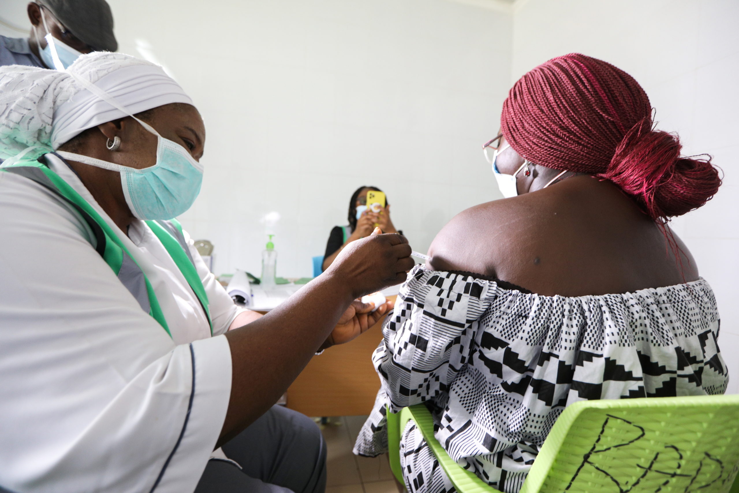 A medical worker injects the AstraZeneca's COVID-19 vaccine to a woman at the Nationa Hospital in Abuja