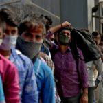 People wait in a line to enter the Lokmanya Tilak Terminus railway station, amid the spread of the coronavirus disease (COVID-19) in Mumbai