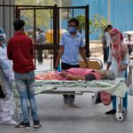 A patient lies in a bed as she is being shifted to a hospital for treatment, amidst the spread of the coronavirus disease (COVID-19) in Ahmedabad