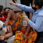 FILE PHOTO: A woman mourns after her father died due to the coronavirus disease (COVID-19) outside a mortuary of a COVID-19 hospital in New Delhi