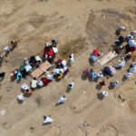 People bury the bodies of COVID-19 victims in New Delhi