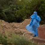 People bury the bodies of COVID-19 victims in New Delhi