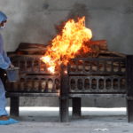FILE PHOTO: Frontline workers prepare a funeral pyre on the outskirts of Mumbai