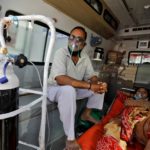 Patients with breathing problem wait inside an ambulance to enter a COVID-19 hospital for treatment, in Ahmedabad