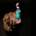 FILE PHOTO: A man displays a vial AstraZeneca's COVISHIELD vaccine as the country receives its first batch of coronavirus disease (COVID-19) vaccines under COVAX scheme, in Accra