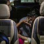 A person with a breathing problem receives oxygen support for free inside her car at a Gurudwara, in Ghaziabad