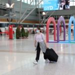 FILE PHOTO: People wearing masks walk through Sydney Airport in the wake of a COVID-19 outbreak in Sydney
