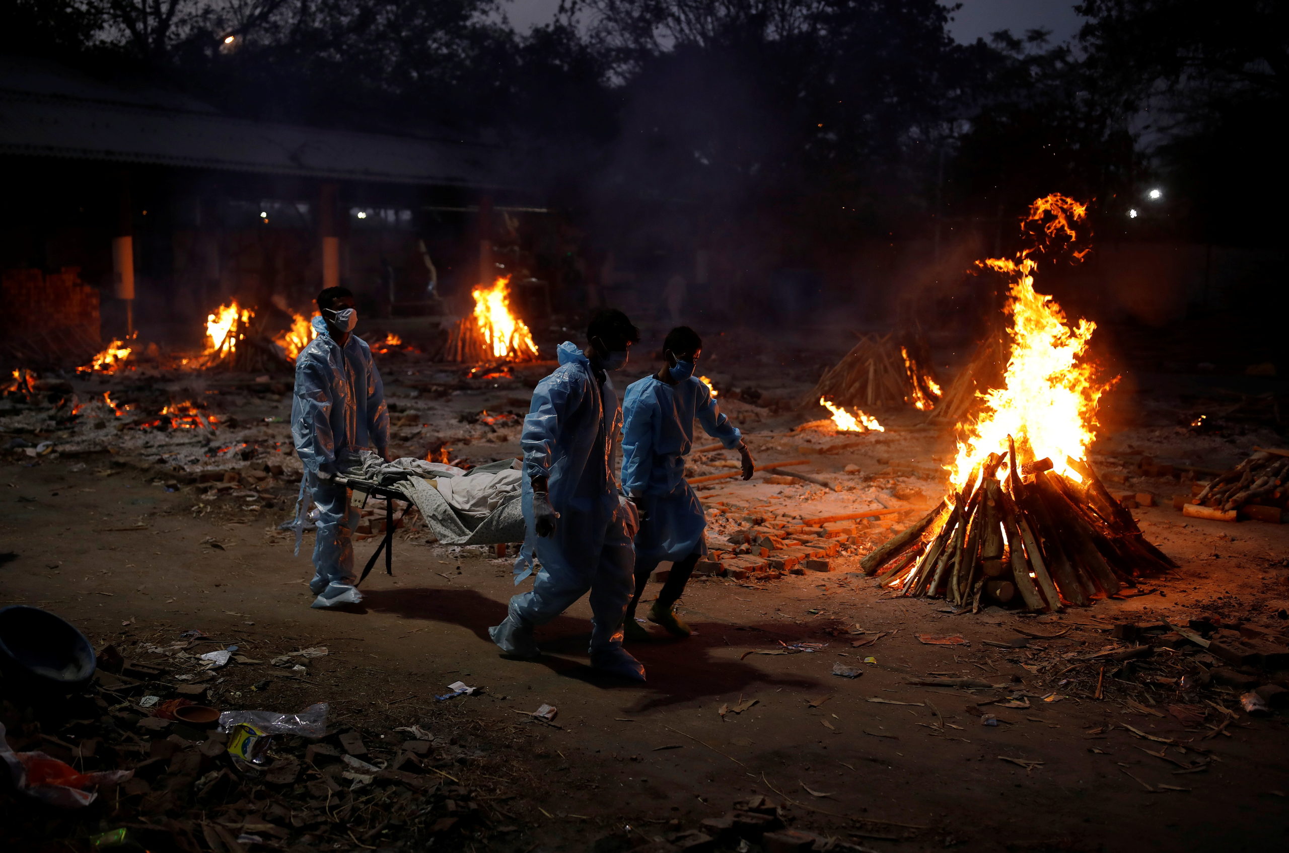 People carry a body of a man, who died from the coronavirus disease (COVID-19), during his cremation at a crematorium in New Delhi