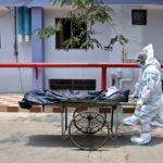Healthcare workers transfer the body of a person who died from the coronavirus disease (COVID-19), inside a hospital premises in Kolkata