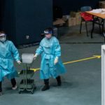 FILE PHOTO: Medical professionals push a collecting cart at the community testing centre for the coronavirus disease (COVID-19) in Hong Kong