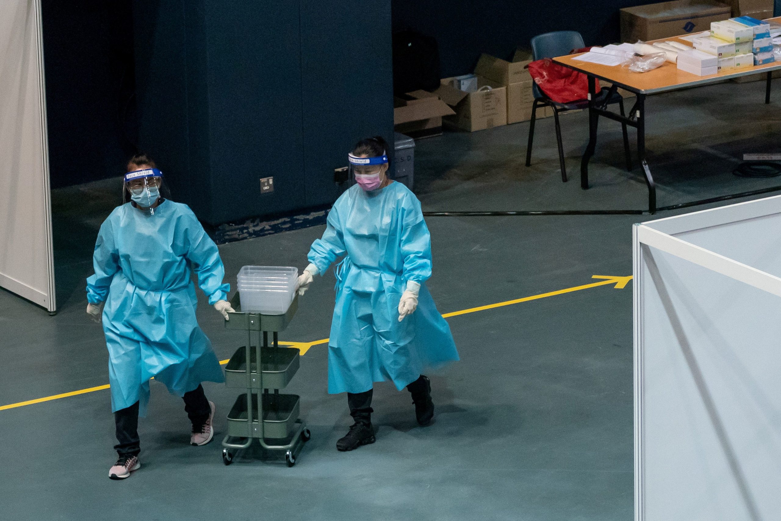 FILE PHOTO: Medical professionals push a collecting cart at the community testing centre for the coronavirus disease (COVID-19) in Hong Kong