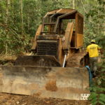 FILE PHOTO: A member of the Chico Mendes Institute for Biodiversity Conservation (ICMBio) walks next a tractor used for deforestation at the National Forest Bom Futuro in Rio Pardo