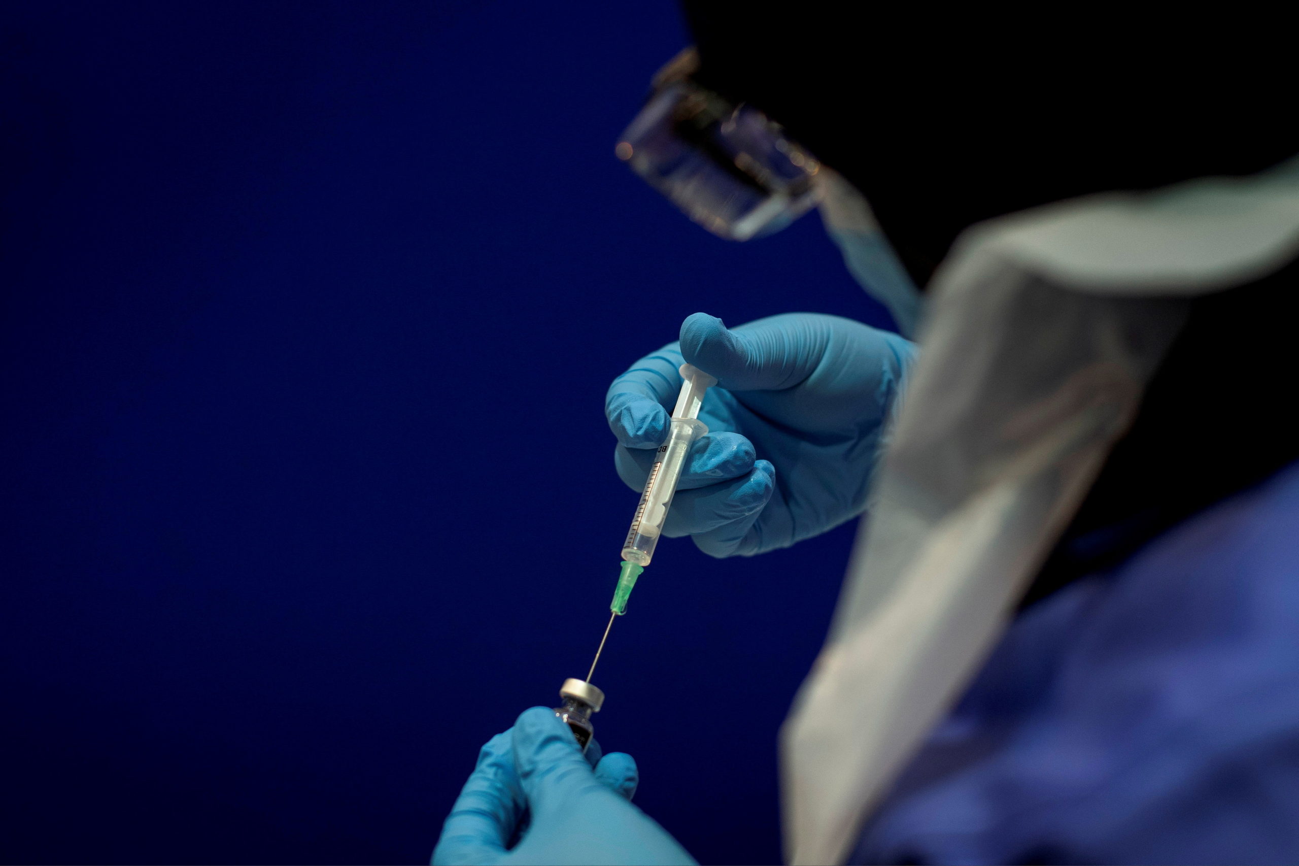 FILE PHOTO: A phial of the Pfizer/BioNTech COVID-19 vaccine concentrate is diluted with 1.8ml sodium chloride ready for use at Guy's Hospital in London