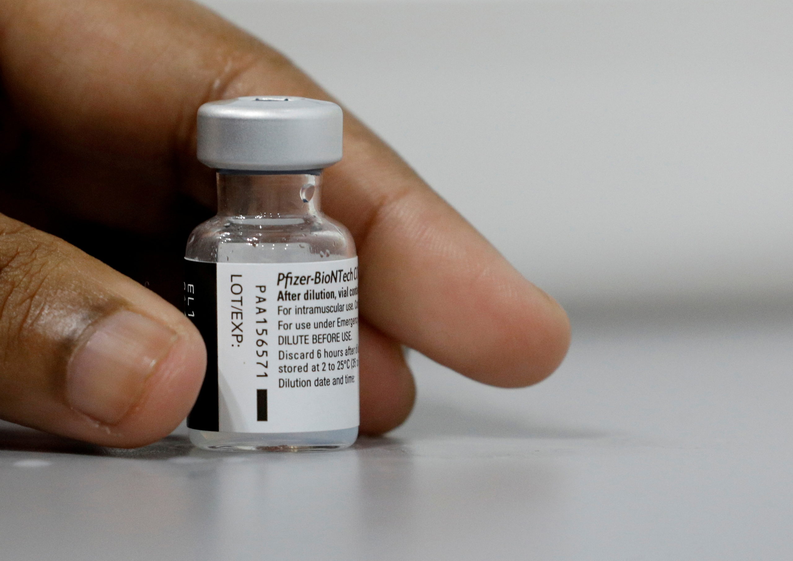 FILE PHOTO: A medical worker prepares to dilute a vial of Pfizer-BioNTech vaccine at a coronavirus disease (COVID-19) vaccination center in Singapore
