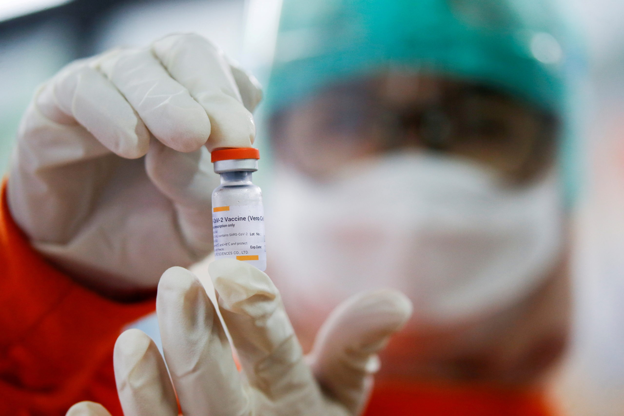 FILE PHOTO: A medical worker holds a dose of the Sinovac vaccine at a district health facility as Indonesia begins mass vaccination for the coronavirus disease (COVID-19), in Jakarta