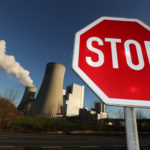 Stop sign stands in front of the Neurath lignite power plant