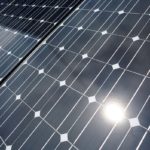 FILE PHOTO: The sun is reflected on a solar panel at a solar power field in Kawasaki, near Tokyo
