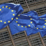 FILE PHOTO: European Union flags flutter outside the EU Commission headquarters in Brussels