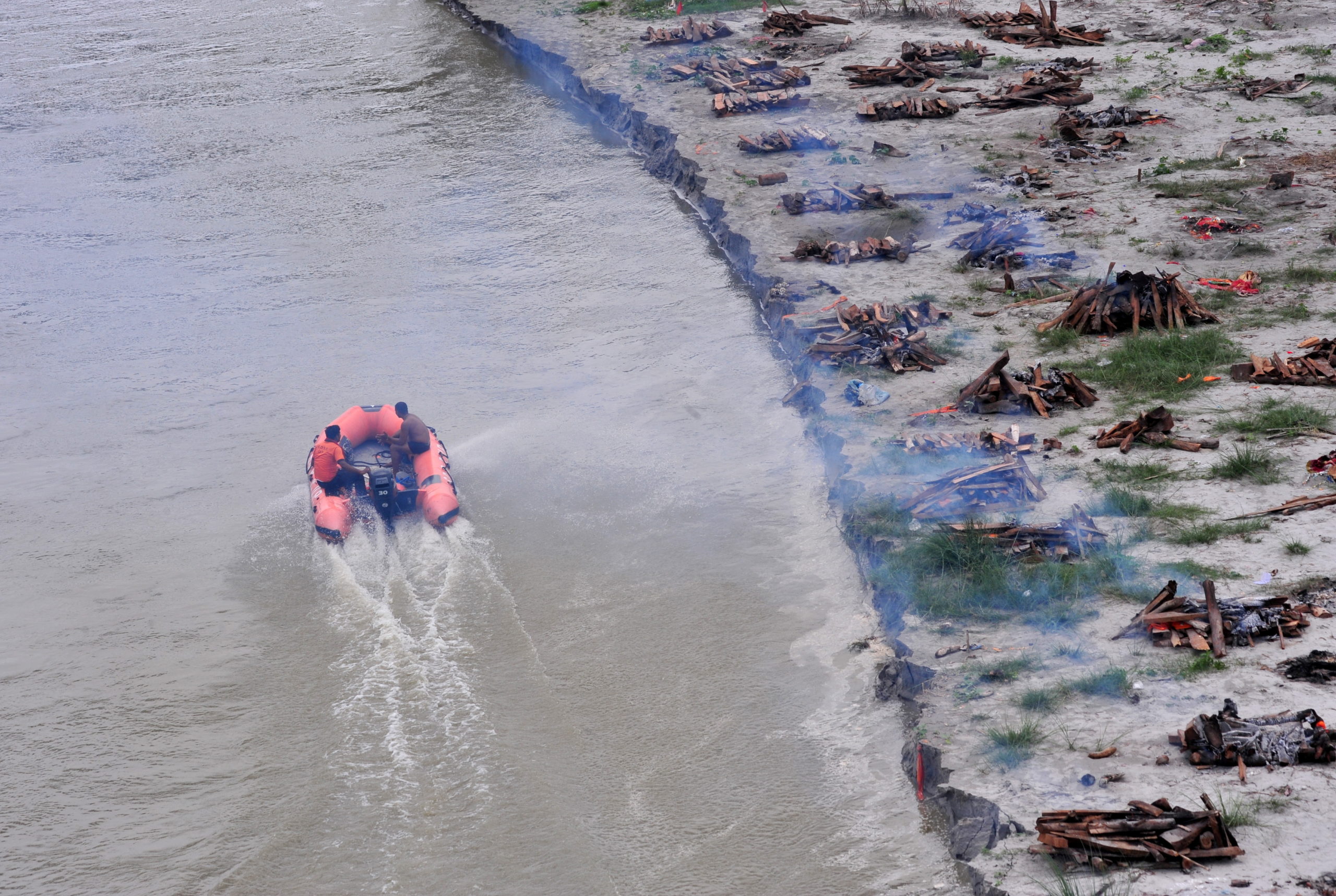 FILE PHOTO: Monsoon exposes bodies buried in shallow sand graves in Phaphamau