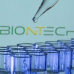 FILE PHOTO: Test tubes are seen in front of a displayed Biontech logo in this illustration