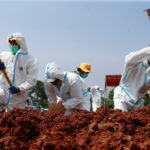 Gravediggers work at Muslim burial area for COVID-19 victims provided by government, in Bekasi