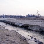 Sand-dredging boats are seen near an area cleared for sand mining, on Poyang Lake in Jiujiang