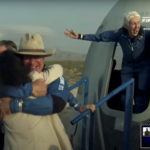 Billionaire businessman Jeff Bezos and pioneering female aviator Wally Funk emerge from their capsule