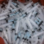 FILE PHOTO: Used syringes lie discarded in a bin after they were used to administer the coronavirus disease (COVID-19) vaccine in Mumbai