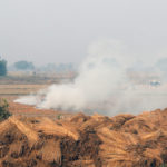 Smoke billows from paddy waste stubble as it burns in a field near Jewar