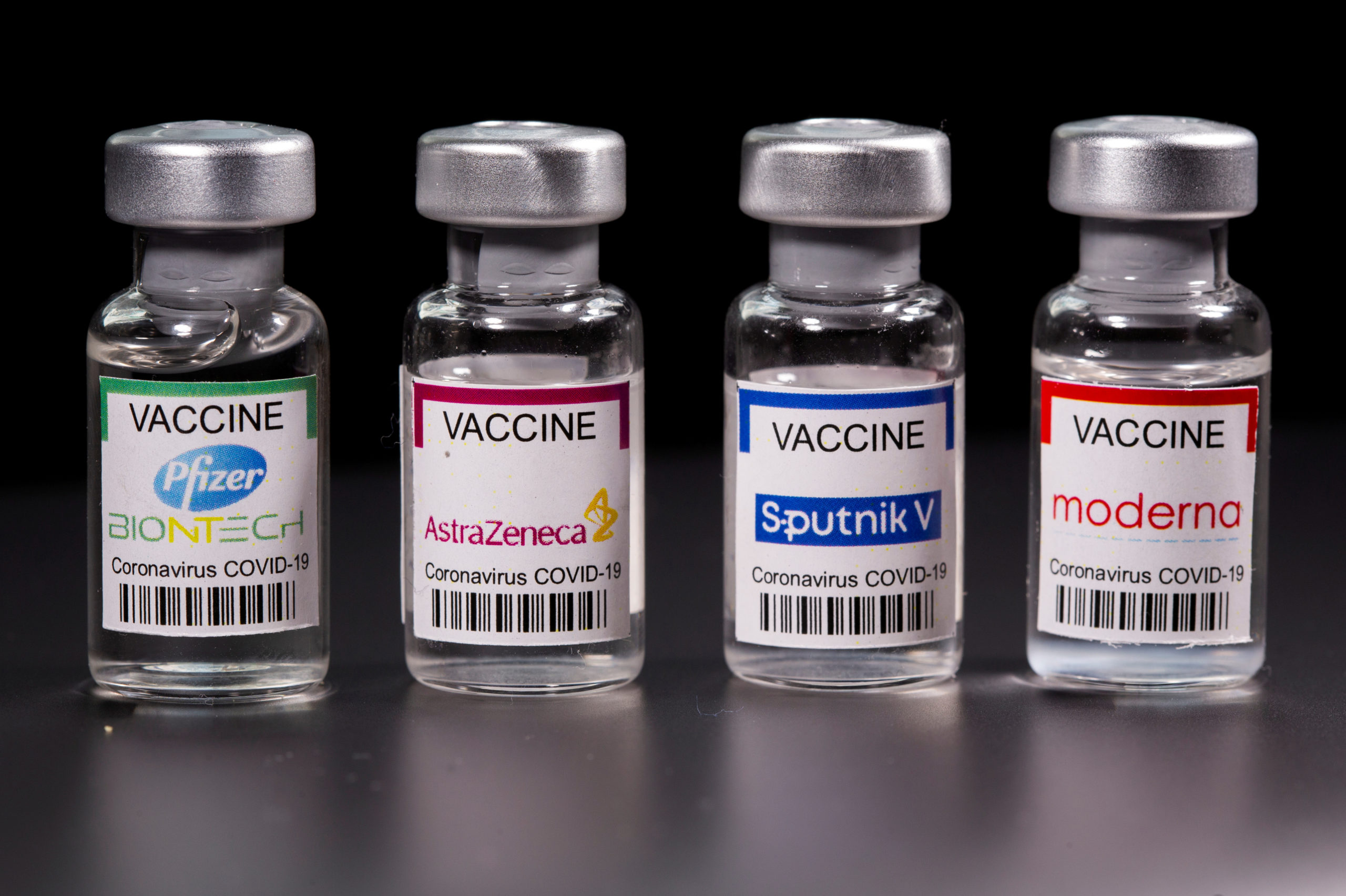 FILE PHOTO: Picture illustration of vials with Pfizer-BioNTech, AstraZeneca, Sputnik V, and Moderna coronavirus disease (COVID-19) vaccine labels