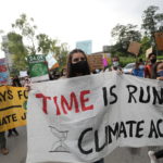 FILE PHOTO: People hold banners and signs as they take part in a "Fridays for Future" march calling for urgent measures to combat climate change, in New Delhi, India,