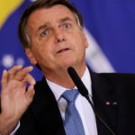 FILE PHOTO: Brazil's President Jair Bolsonaro attends the ceremony for the Modernization of Occupational Health and Safety Regulations, in Brasilia
